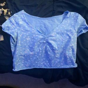 Blue crop top with white flowers. Super cute with straight leg jeans.